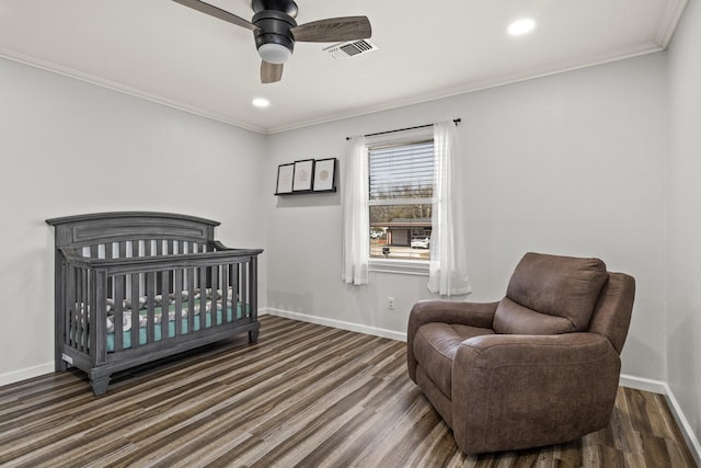 bedroom with crown molding, dark wood-style flooring, and baseboards