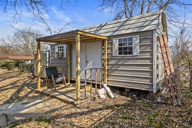 view of outbuilding featuring an outbuilding and fence