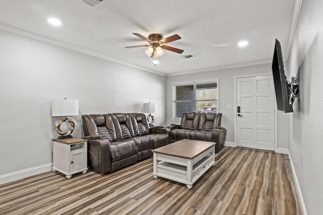 living area featuring baseboards, dark wood finished floors, a ceiling fan, ornamental molding, and recessed lighting