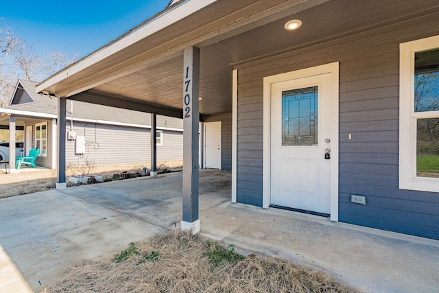 entrance to property with a carport and driveway