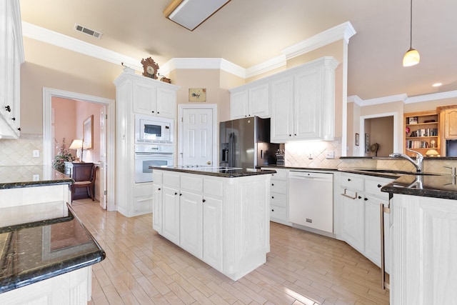 10 Fair Green Dr, Trophy Club, TX 76262 - kitchen featuring white appliances, a sink, backsplash, crown molding, and white cabinets