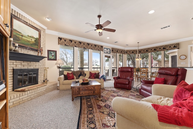 carpeted living area with visible vents, a fireplace, ornamental molding, and recessed lighting