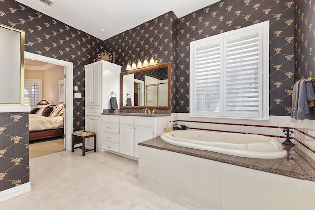 ensuite bathroom with tile patterned floors, ensuite bath, and wallpapered walls