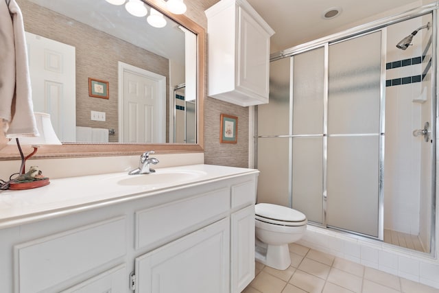 full bathroom with a stall shower, vanity, and tile patterned floors