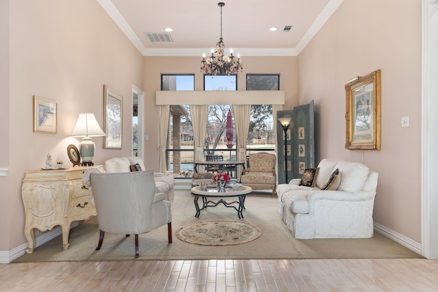 living room featuring visible vents, light wood-style flooring, an inviting chandelier, ornamental molding, and baseboards