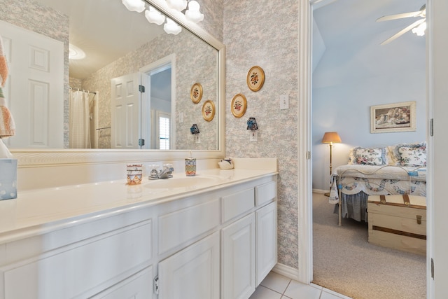 bathroom featuring ceiling fan, vanity, tile patterned floors, ensuite bath, and wallpapered walls