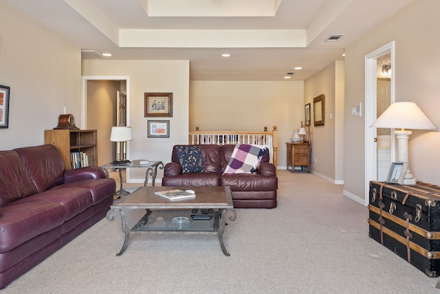 living area with light carpet, a tray ceiling, recessed lighting, and baseboards