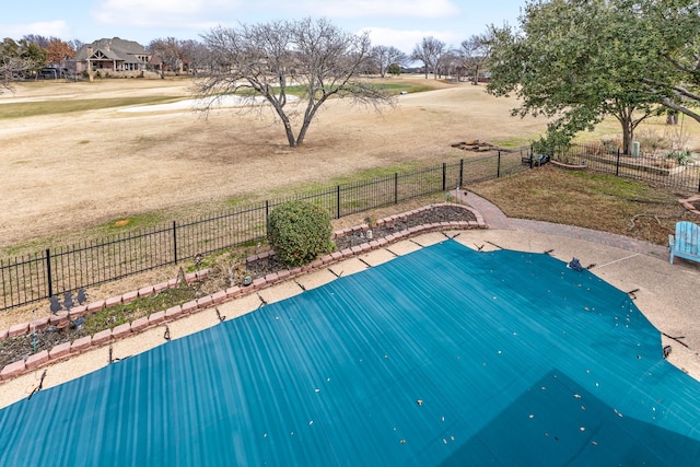 view of pool with a yard and fence