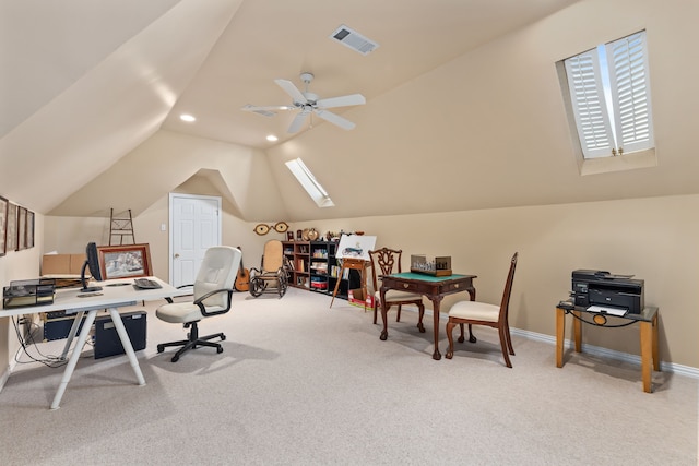 carpeted office with recessed lighting, visible vents, ceiling fan, vaulted ceiling with skylight, and baseboards