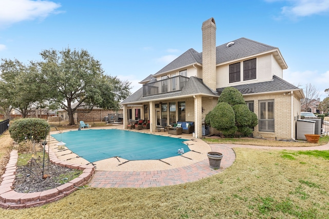 view of pool with a fenced backyard, a lawn, outdoor lounge area, and a fenced in pool