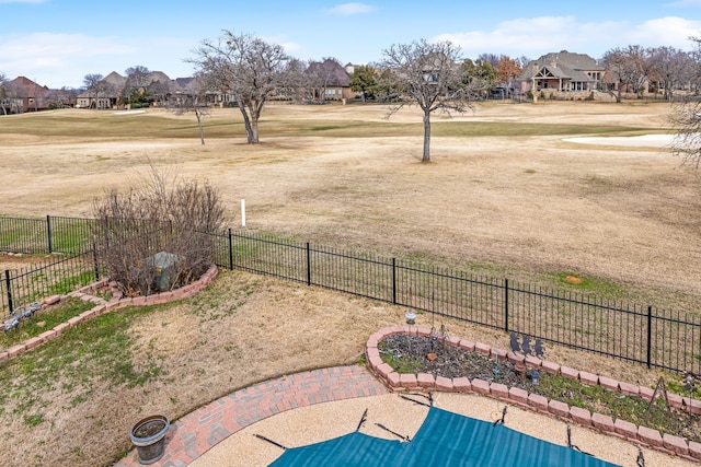 view of yard featuring a fenced backyard and a residential view