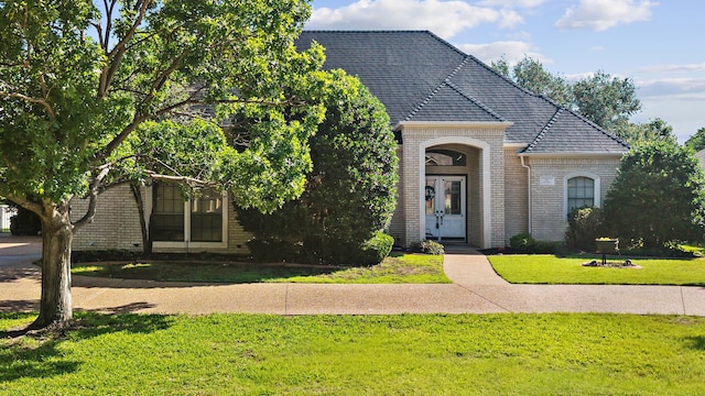10 Fair Green Dr, Trophy Club, TX 76262 - view of front of property with french doors, brick siding, and a front lawn