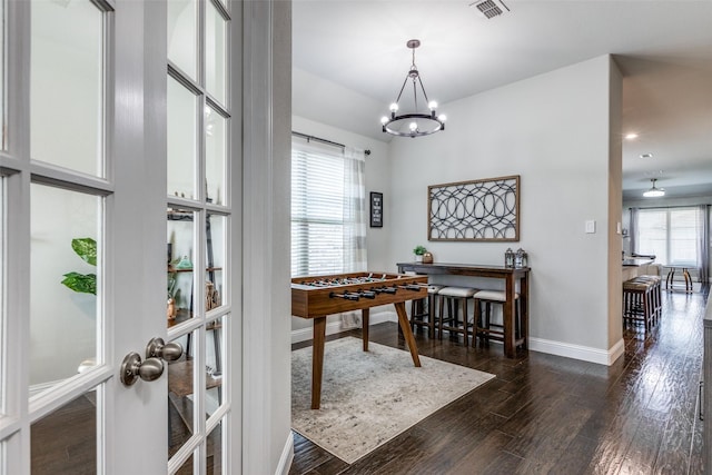 dining area with a chandelier, visible vents, baseboards, french doors, and dark wood finished floors