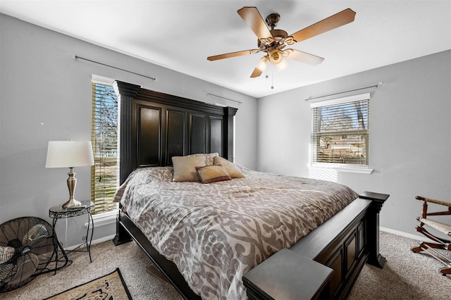 bedroom featuring light carpet, multiple windows, and baseboards