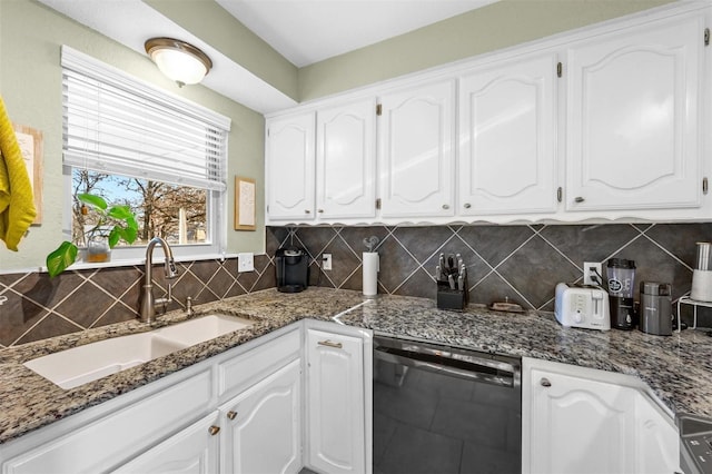 kitchen with white cabinets, dishwasher, and a sink