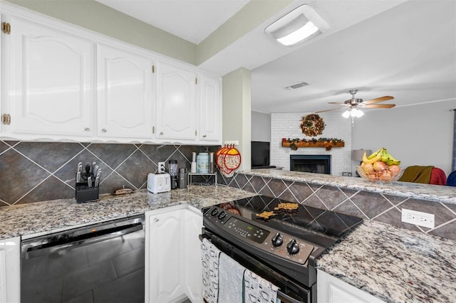 kitchen with black appliances, visible vents, and white cabinetry