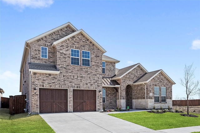 551 Baker Ct, Fate, TX 75189 - traditional-style home featuring an attached garage, driveway, brick siding, a standing seam roof, and roof with shingles