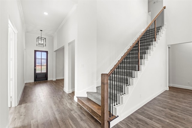 551 Baker Ct, Fate, TX 75189 - entryway with stairs, wood finished floors, a chandelier, baseboards, and a towering ceiling