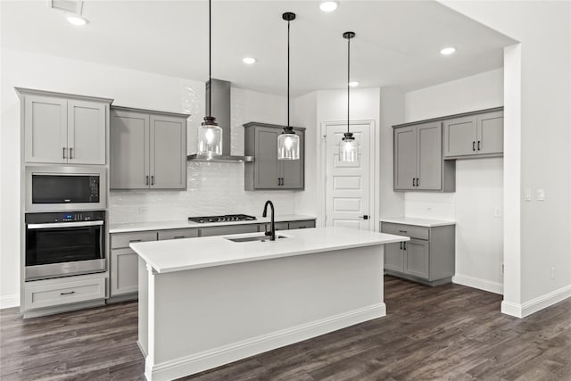 551 Baker Ct, Fate, TX 75189 - kitchen with oven, gray cabinetry, wall chimney range hood, a sink, and gas stovetop