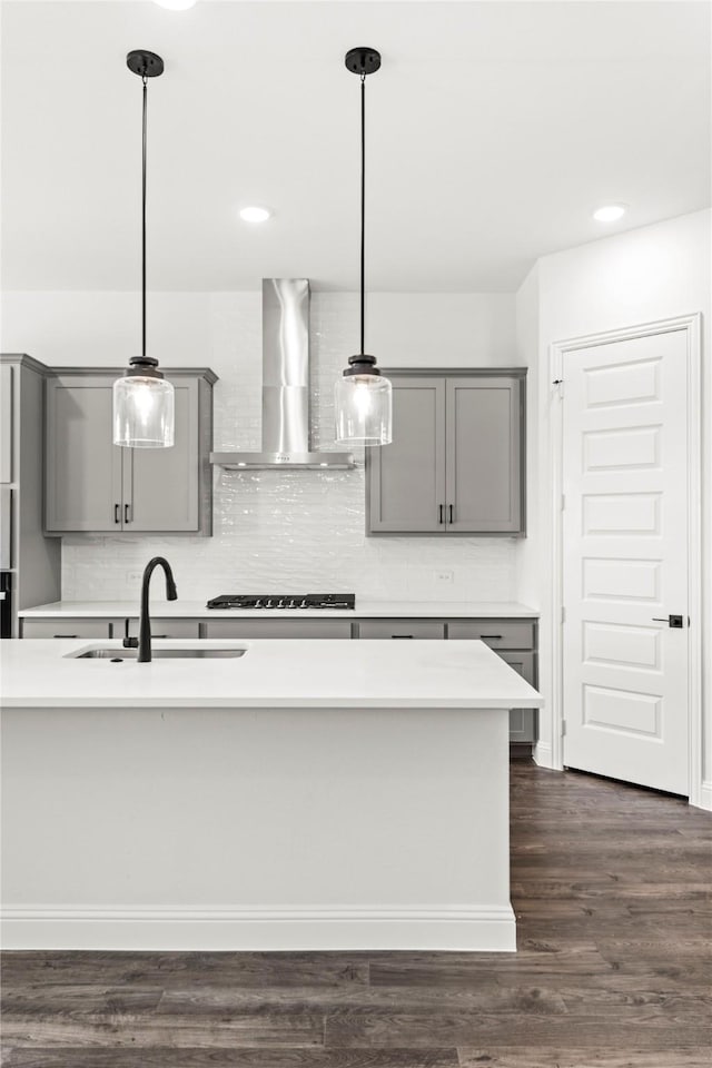 551 Baker Ct, Fate, TX 75189 - kitchen with gray cabinetry, wall chimney range hood, a sink, black stovetop, and light countertops