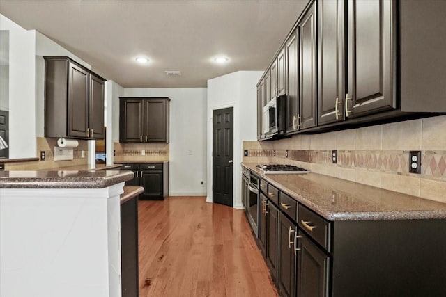 kitchen featuring recessed lighting, visible vents, backsplash, appliances with stainless steel finishes, and light wood-type flooring