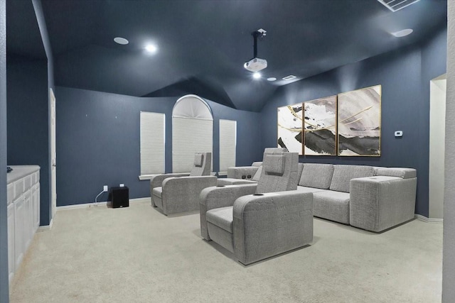 carpeted cinema with baseboards and vaulted ceiling