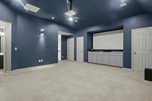 home theater room featuring carpet, visible vents, and baseboards