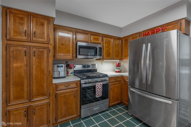 kitchen with brown cabinets, stainless steel appliances, and light countertops