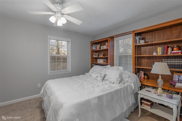 bedroom featuring baseboards, ceiling fan, and light colored carpet