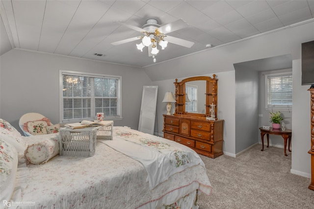 bedroom with light colored carpet, vaulted ceiling, baseboards, and ceiling fan