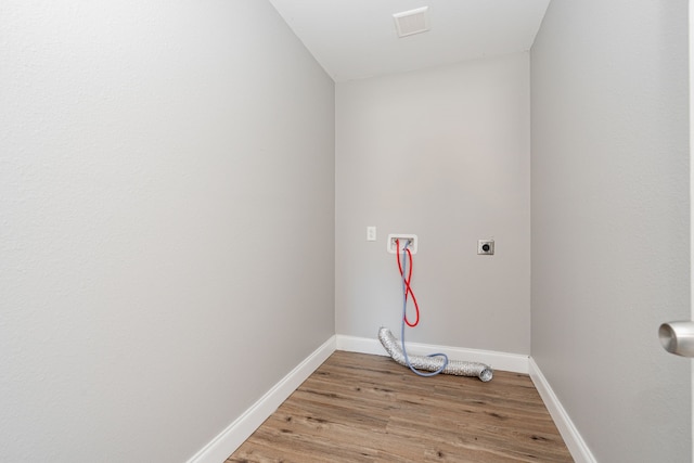 laundry room featuring laundry area, visible vents, hookup for an electric dryer, light wood-style floors, and washer hookup