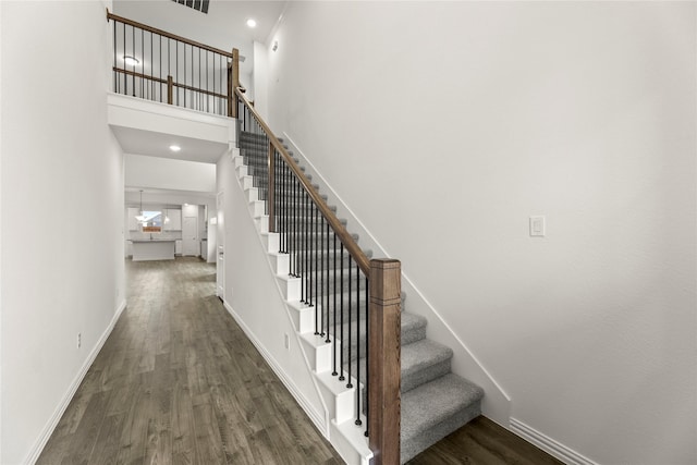 279 Bright Alcove Ct, Lavon, TX 75166 - staircase featuring wood finished floors, baseboards, and a towering ceiling