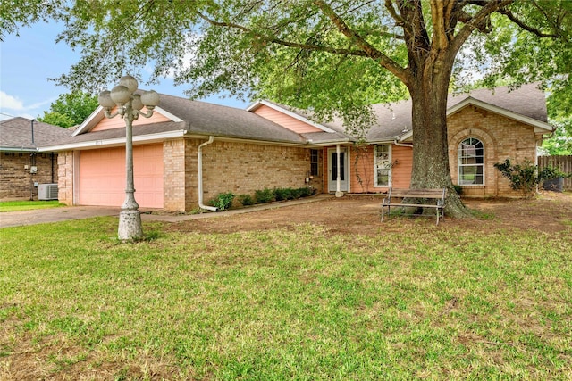 single story home with brick siding, roof with shingles, an attached garage, a front yard, and driveway