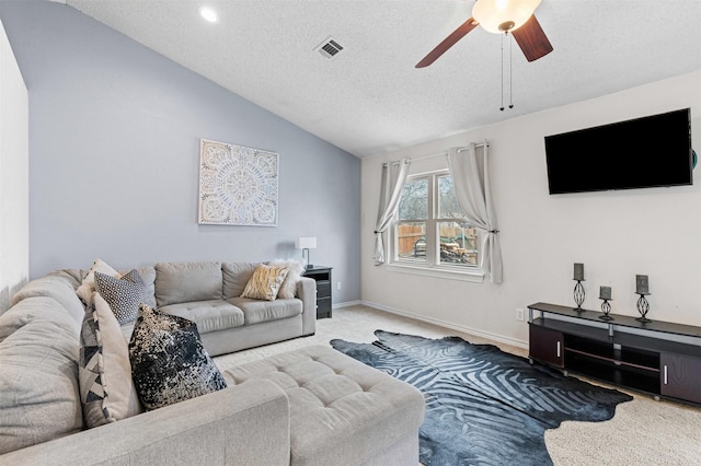 carpeted living room featuring visible vents, vaulted ceiling, a textured ceiling, ceiling fan, and baseboards