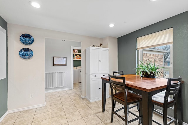 dining space featuring light tile patterned floors, recessed lighting, washing machine and clothes dryer, and baseboards