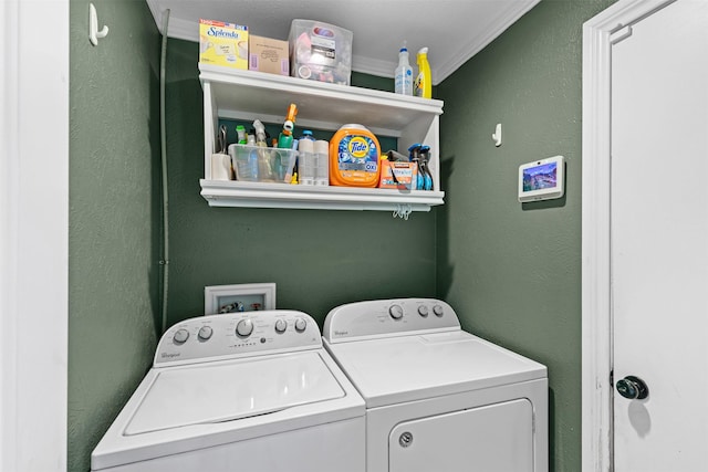 laundry area featuring crown molding, a textured wall, laundry area, and independent washer and dryer