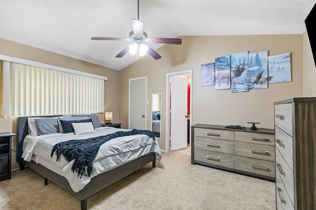 bedroom with lofted ceiling, ceiling fan, a textured ceiling, and light colored carpet