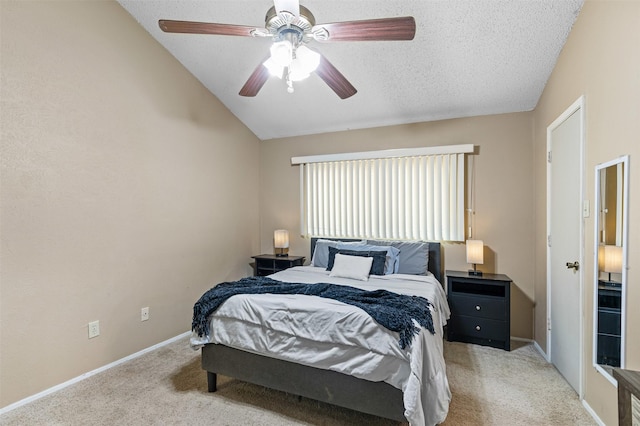 bedroom with lofted ceiling, a textured ceiling, light colored carpet, a ceiling fan, and baseboards