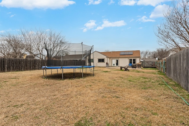 view of yard featuring a fenced backyard and a trampoline