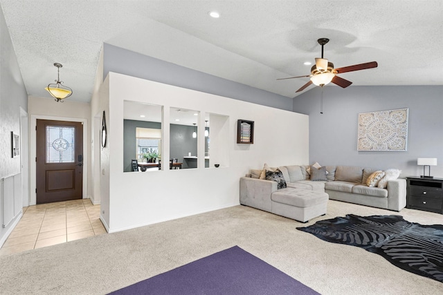 living room featuring light carpet, light tile patterned floors, vaulted ceiling, and a textured ceiling