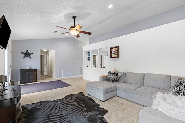 living area featuring visible vents, a ceiling fan, light carpet, vaulted ceiling, and a textured ceiling