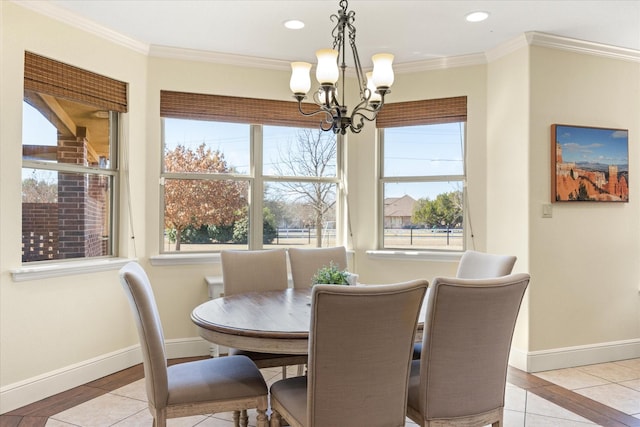 dining area with a wealth of natural light, light tile patterned floors, crown molding, and an inviting chandelier