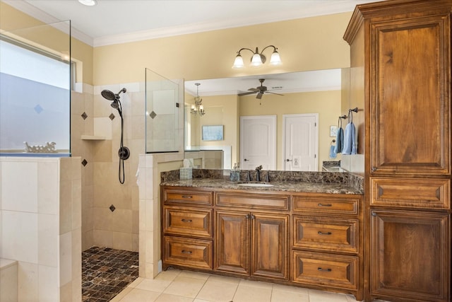 bathroom featuring ceiling fan, ornamental molding, tile patterned flooring, walk in shower, and vanity