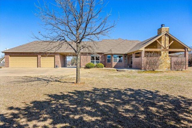 view of front of house featuring an attached garage, driveway, a chimney, and brick siding