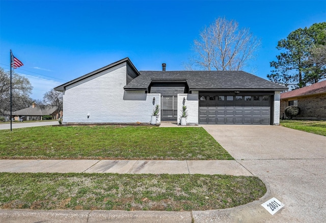 mid-century modern home with a front lawn, an attached garage, driveway, and a shingled roof