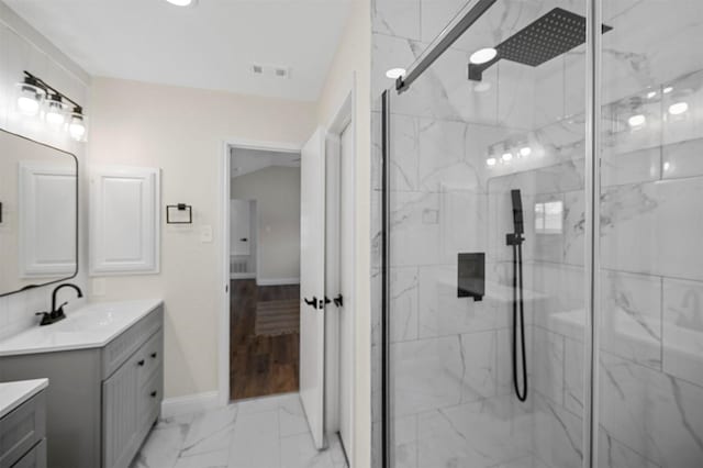 full bathroom with a marble finish shower, marble finish floor, vanity, and visible vents