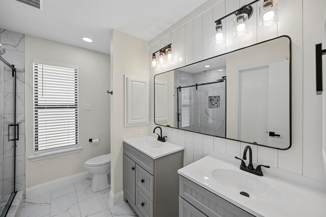 bathroom with a stall shower, two vanities, marble finish floor, and a sink