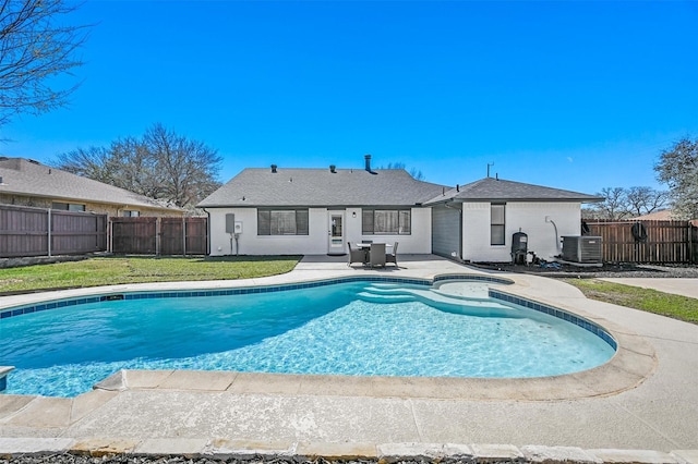 view of pool featuring a patio, a fenced in pool, a yard, a fenced backyard, and central AC