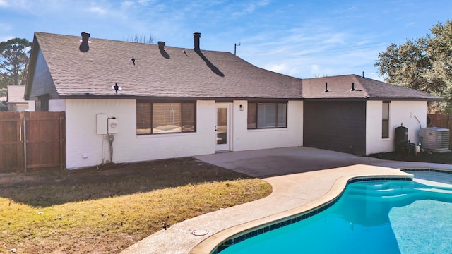 back of house with a patio, fence, a fenced in pool, and roof with shingles