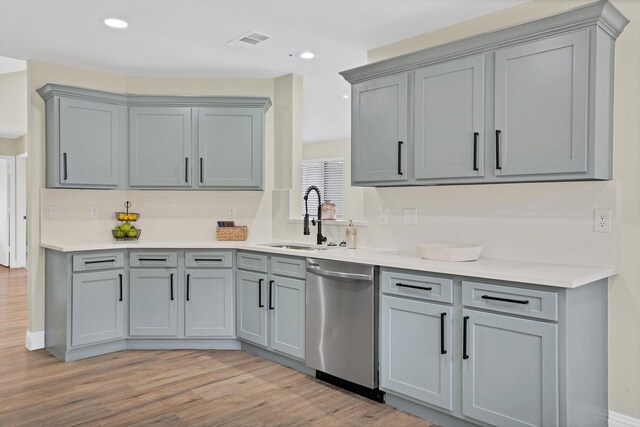 kitchen featuring visible vents, light wood-style floors, dishwasher, and gray cabinetry